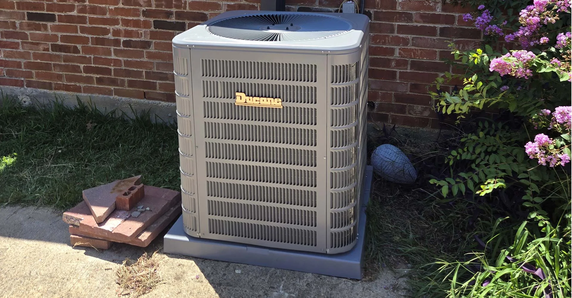 Refrigerant lines inspected for leaks at an outdoor AC unit