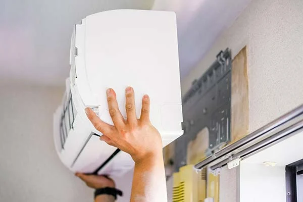 Technician servicing a ductless mini-split system in the DFW area
