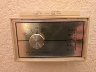Smart thermostat installation replacing an old unit in a North Texas home