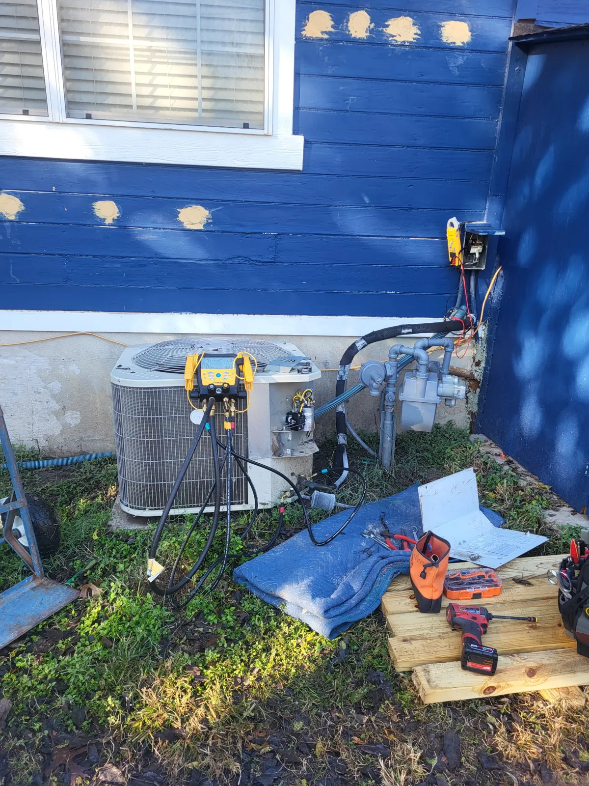 Manifold gauges connected to a condenser during an HVAC inspection in Midlothian, Texas