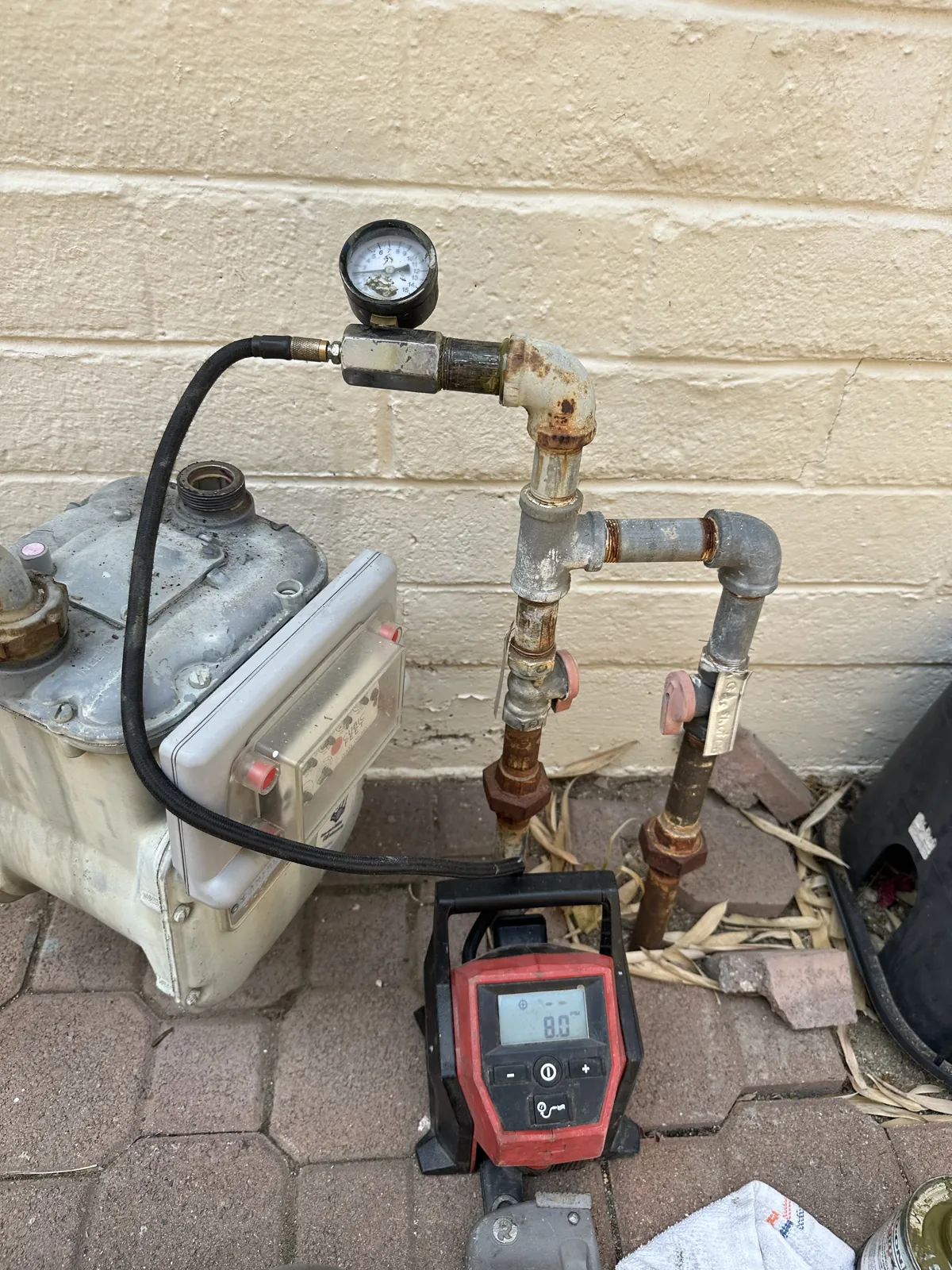 Gas pressure test gauge connected at the meter during a home purchase HVAC inspection