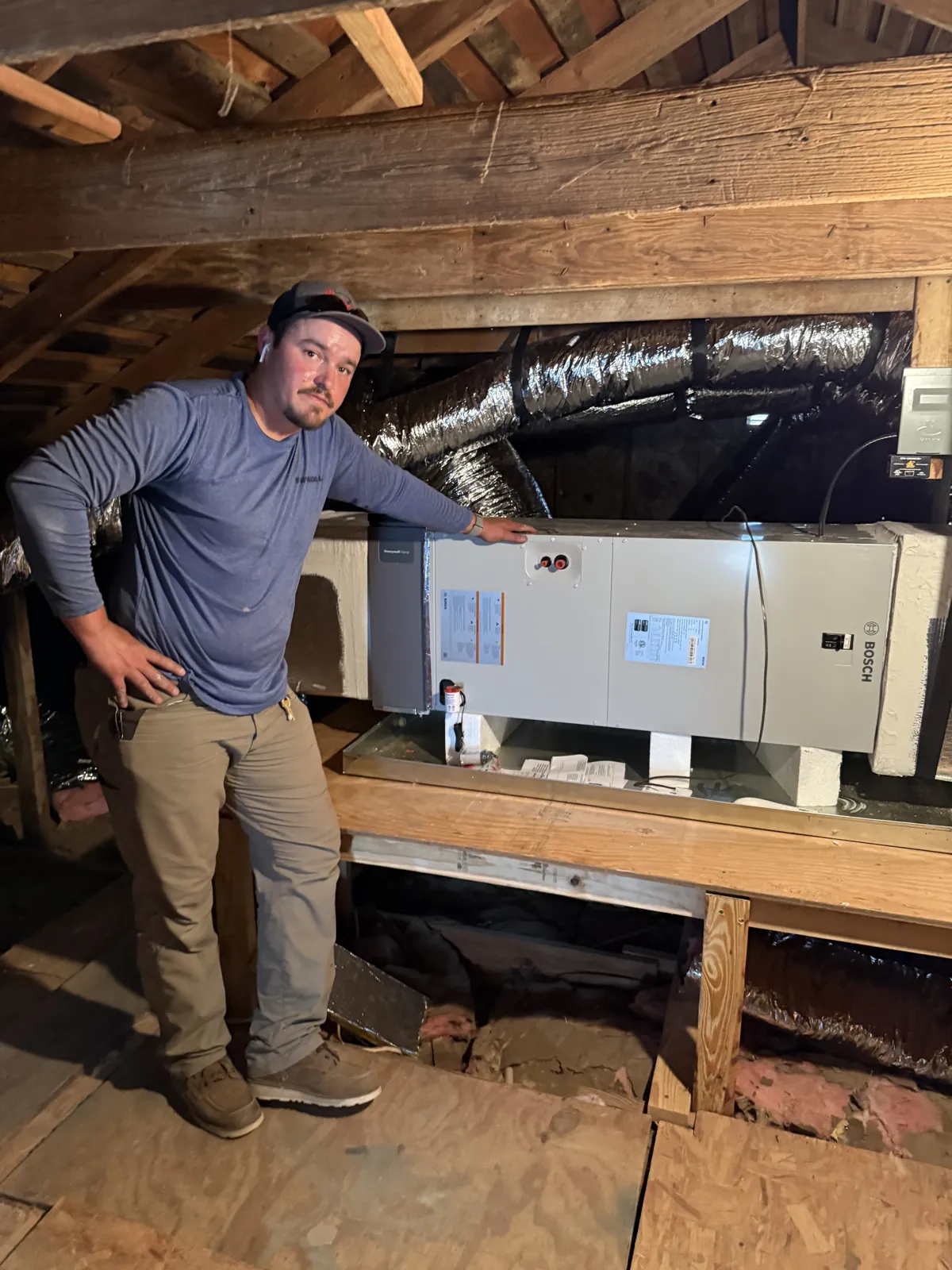 Technician at an attic air handler